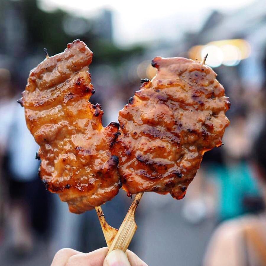 Premium Photo  Closeup of grilled skewered milk pork on stick thai street  food market