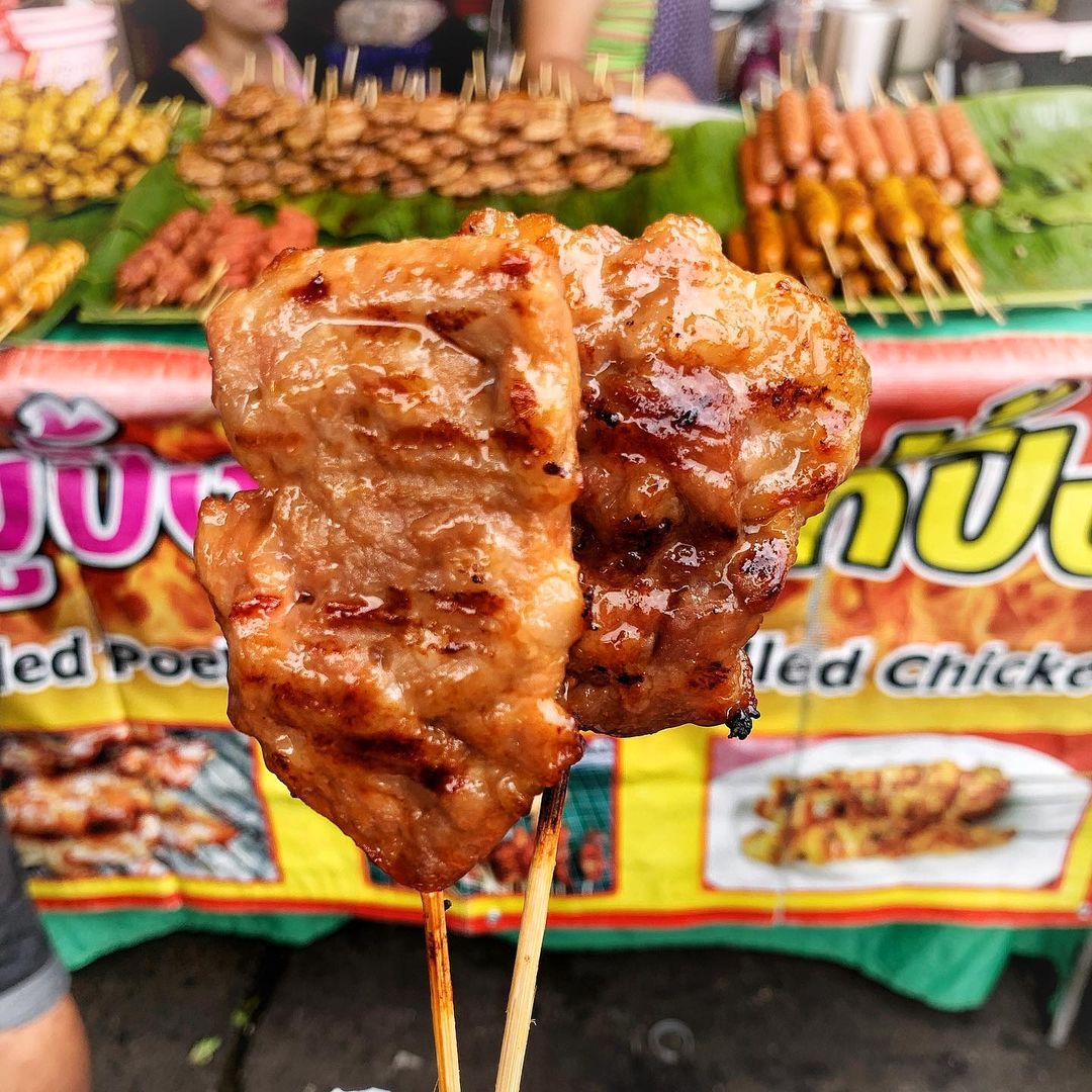 Premium Photo  Closeup of grilled skewered milk pork on stick thai street  food market